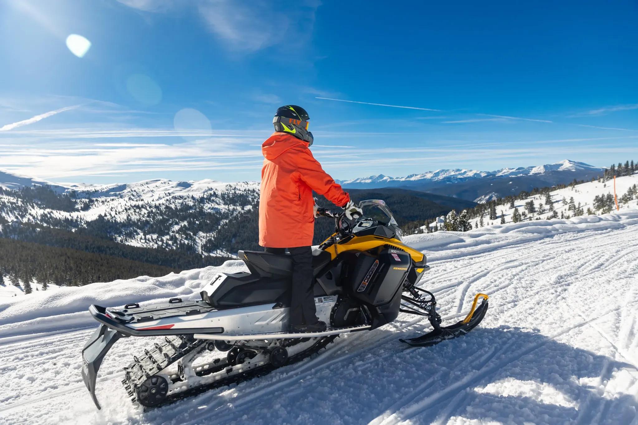Snowmobile parked with a panoramic mountain backdrop